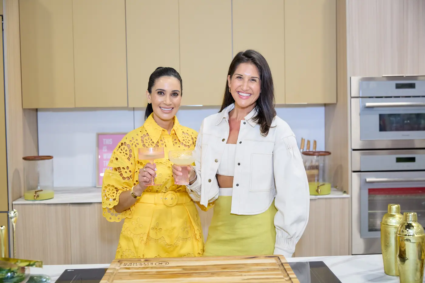 Presenters smiling behind a marble kitchen island at the Home Show