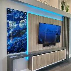 Modern living room with LED media wall, large TV, and blue-lit glass artwork