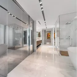 Luxury master bathroom with marble floors, glass shower rooms, and freestanding tub