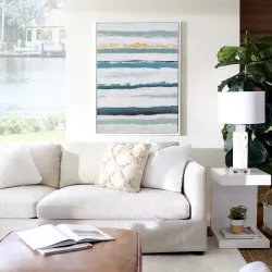 Casual living room with white linen sofa, abstract canvas art, and fiddle-leaf fig plant