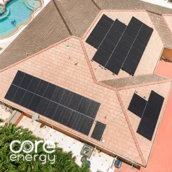 Aerial view of black solar panels on pitched clay tile roof beside backyard pool, Core Energy logo