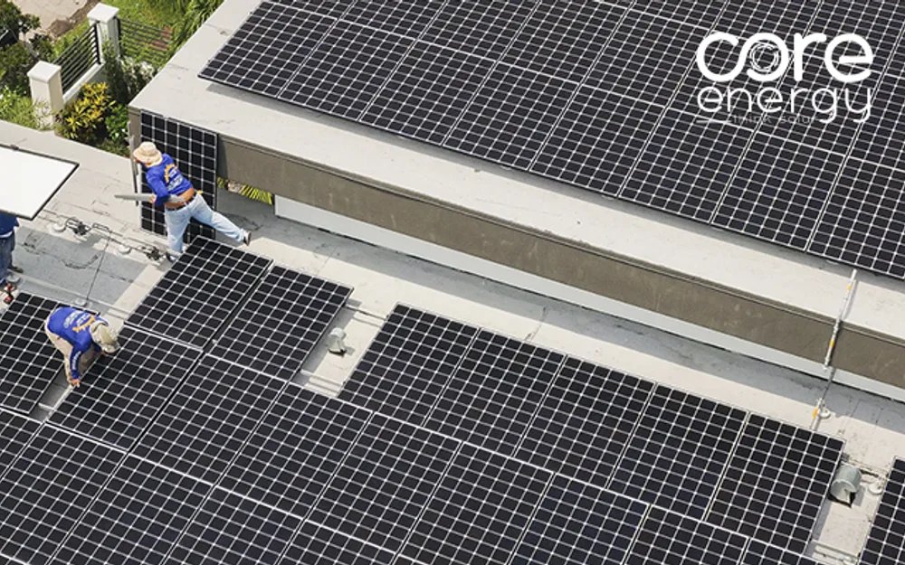 Workers installing solar panels on a commercial rooftop, Core Energy, aerial view