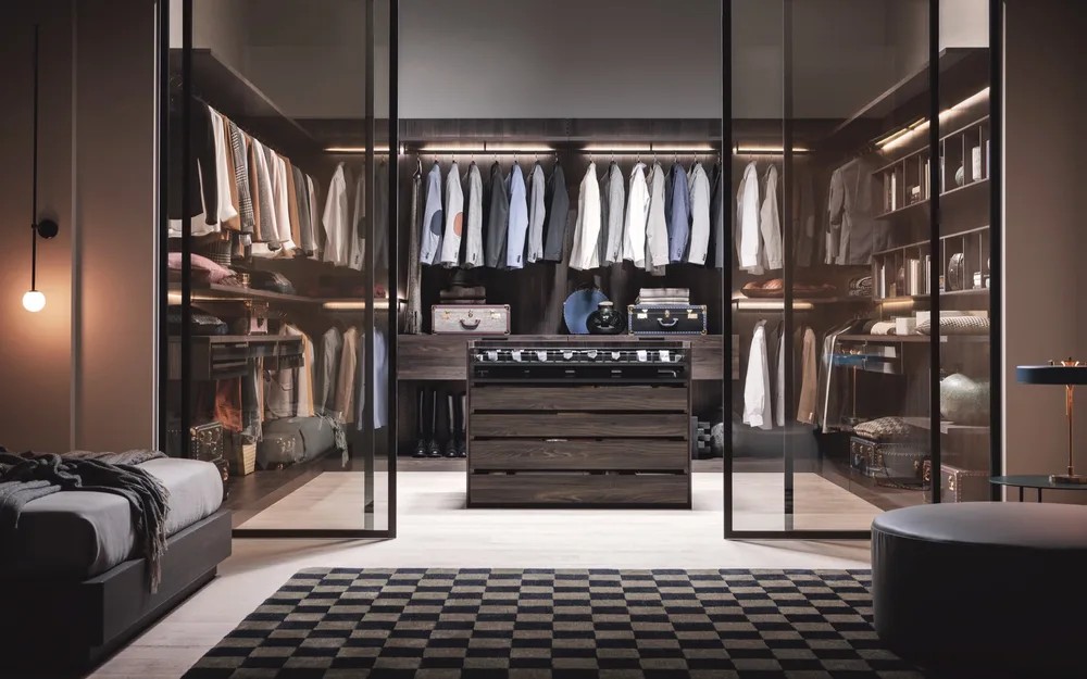 Snaidero floor-to-ceiling wardrobe wall in linen gray with blue accent niches and sofa in foreground
